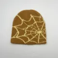 Close-up of brown knit beanie showing fuzzy mohair texture and yellow spider web pattern - One Size / Brown Spider Web