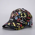 Macro shot of street graffiti pattern and embroidered streamers on black baseball cap - Black Graffiti +82