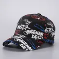 Close-up of black cotton baseball cap featuring colorful graffiti and artistic text prints - Black-STER
