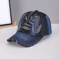 Dark blue denim baseball cap featuring sparkling rhinestone flower patterns and orange stitching - Bamboo Leaf Dark Blue