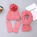 Detailed flat lay of pink winter knit set with pompom hat, scarf, and touchscreen gloves - Hat with Pom-poms / Watermelon red