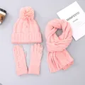 Pink cable knit winter set featuring a faux fur pompom hat, scarf, and touchscreen gloves - Pink