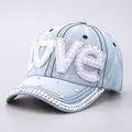 Detailed close-up of denim baseball cap with LOVE rhinestone and pearl embroidery - Pearl Rhinestone LOVE Style / Light Blue Pearl Rhinestone LOVE