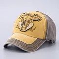 Close-up of vintage washed cotton baseball cap featuring bull skull embroidery detail - Adjustable / Yellow Bull Head Patch