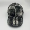 Close-up of winter baseball cap with textured black and white leopard pattern faux shearling - Lamb Fleece Style / Black Plaid