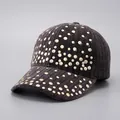 Detailed view of dark grey baseball cap featuring golden stud rivets and ribbed texture - Black - Full Rivet Hot Stamping