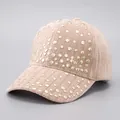 Detail view of corduroy baseball cap featuring golden stud rivets on beige fabric - Khaki - Full Rivet Hot Stamping