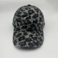 Detailed texture of leopard print faux shearling fabric on winter baseball cap - Warm Lamb Wool Style / Black and Grey Leopard