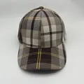 Detail of British style striped baseball cap showing plaid pattern and brim stitching - Adjustable / Coffee and White Houndstooth