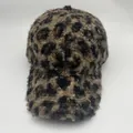 Close-up of the plush leopard print faux shearling texture on a winter baseball cap - Warm Lamb Wool Style / Brown Black Leopard