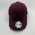 Detailed view of dark red baseball cap fabric with ventilation holes and silver sticker - M (56-58cm) / Wine Red Plain