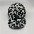 Detailed texture of black and white leopard print faux fur on a warm baseball cap - Warm Lamb Wool Style / White & Black Leopard Print