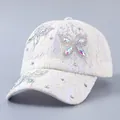Detail of white floral lace baseball cap featuring shimmering rhinestone butterfly pattern - Butterfly Design / Beige