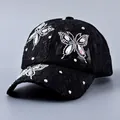 Close-up of black lace baseball cap with sparkling crystal butterfly embellishments - Butterfly Design / Black