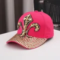 Detailed macro view of rhinestone fleur-de-lis pattern on a hot pink cotton baseball cap - Adjustable / Rose Red