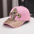 Detail of pink cotton baseball cap with gold fleur-de-lis rhinestones and crystal brim - Adjustable / Pink