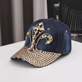 Navy denim baseball cap featuring ornate rhinestone fleur-de-lis patterns and curved brim - Adjustable / Dark Blue Denim