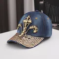 Detailed view of luxury rhinestone fleur-de-lis pattern on a navy denim baseball cap - Adjustable / Medium Blue Denim