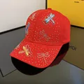Detailed close-up of rhinestone dragonfly patterns on a premium red baseball cap - Adjustable / 3D Dragonfly - Red