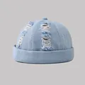 Front view of a distressed light blue washed denim skull cap with stylish ripped details - Adjustable / Light Blue