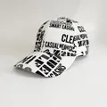 Detail view of the baseball cap with all-over black letter print on white fabric - Adjustable / White Large Letter Printing