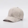 Detailed view of the soft faux suede fabric and stitching on a beige baseball cap - Adjustable / Beige