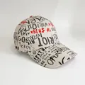Macro shot of street style baseball cap featuring black and red graffiti print patterns - Adjustable / Khaki Small Letter Printing