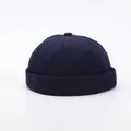 Detailed stitching and fabric texture on a deep blue minimalist docker hat with top button - Adjustable / Navy Blue