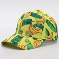 Detail of a bright yellow baseball cap featuring realistic banana and tropical leaf prints - Adjustable / Banana 3 (Yellow Base)