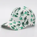 Detail view of white baseball cap with green cactus and pink flower prints on the brim - Adjustable / Cactus 4 (White Base)