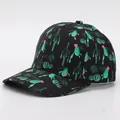Detail view of adult baseball cap with green cactus prints on black fabric background - Adjustable / Cactus 5 (Black Base)