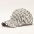 Close-up of elegant black and white tweed baseball cap with textured weave and curved brim - Adjustable / Thin Striped Beige