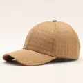 Detail of khaki plaid texture on a warm baseball cap with curved brim and top button - Small Grid / Tan