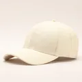 Detailed close-up of cream baseball cap featuring embossed M pattern and textured fabric - Letter M / Off White