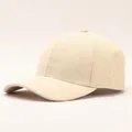 Detail of beige baseball cap featuring embossed sunflower floral patterns and curved brim - Little Sun / Off White