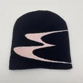 Close-up of black knitted beanie featuring pink geometric jacquard pattern details - One Size / Black Beige Jacquard