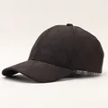Close-up of quilted plaid baseball cap with winter textured diamond pattern on grey background - Diamond Pattern / Black