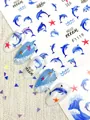 Dettaglio di adesivi 3D per unghie a tema oceano con delfini, stelle marine e onde - Stile Oceano Delfino Blu (F1119)