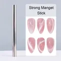 Macro shot of silver cylindrical magnetic wand creating cat-eye nail art effects - Stick Magnet (C24)