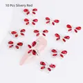 Detail of 10-piece silvery red butterfly nail charms with crystal rhinestones on tips - Silver with Red Gem