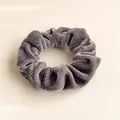 Close-up of grey velvet scrunchie showing detailed soft fabric texture and subtle sheen - Gray