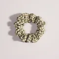 Close-up of green and white gingham fabric scrunchie with soft elastic pleated texture - Green