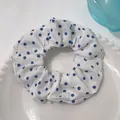 Elegant white scrunchie with blue polka dots on a decorative ceramic plate - Blue Polka Dots on White
