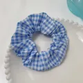 Blue and white gingham hair scrunchie made of soft cotton on a white ceramic plate - Grey Blue Plaid