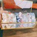Detail of assorted fabric scrunchies set in a luxury glass box on a wooden surface - 10 Pieces Pack / Adored Sunlight