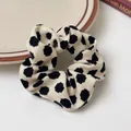 Polka dot leopard pattern scrunchie in cream and black on a minimalist ceramic plate - Milk White