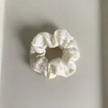 Close-up van de crème geruite stoffen scrunchie met elastische band voor haarstijlen - Beige