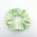 Detail shot of mint green satin hair scrunchie with soft silk luster on white background - Satin 16