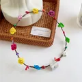 Close-up of colorful LED floral headband with roses and berries in a woven basket - Multicolor Multi-mode Glowing
