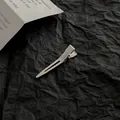 Detail of silver metallic duckbill hair clip on a textured black paper background - S / Silver